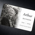 Close view of the memorial wallet card on dark slate showing the gloss finish and printed name