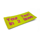 Personalized embroidered patch showcasing custom text in two lines on a bright yellow background.